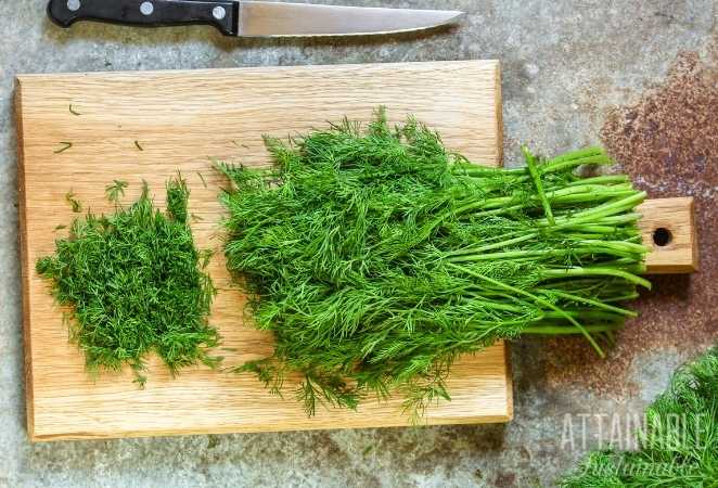 Chopped herbs on cutting board with knife