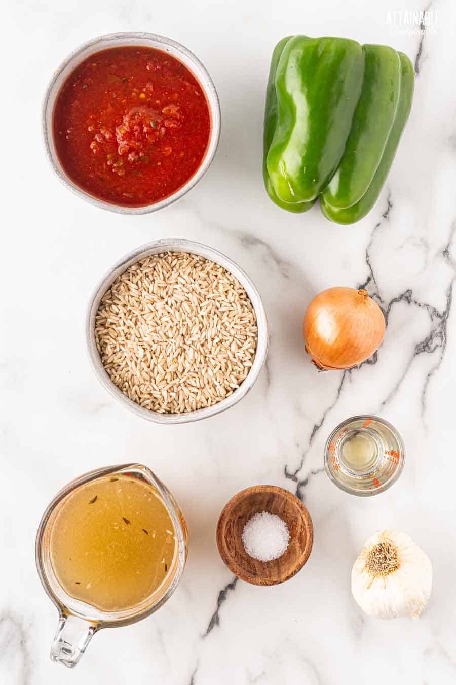 ingredients for spanish rice on a marble background from above.