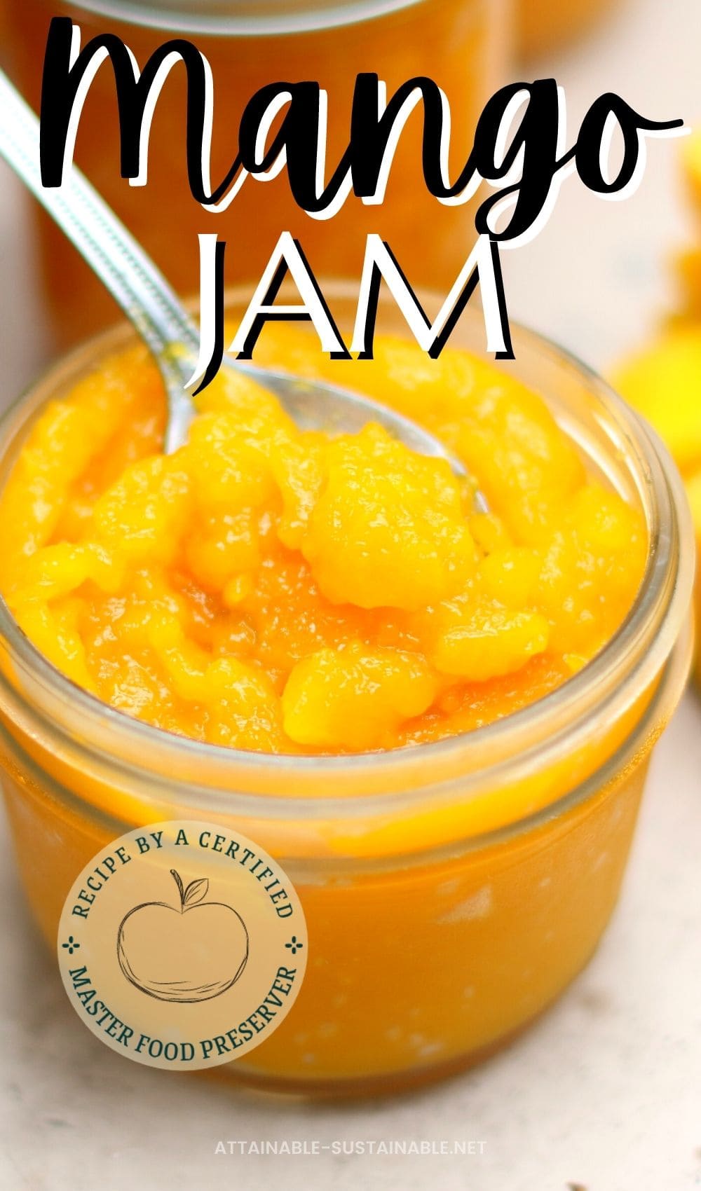 spoon in a jar of bright yellow jam in a canning jar