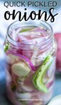glass jar with open lid, sliced red onions, pepper and garlic visible