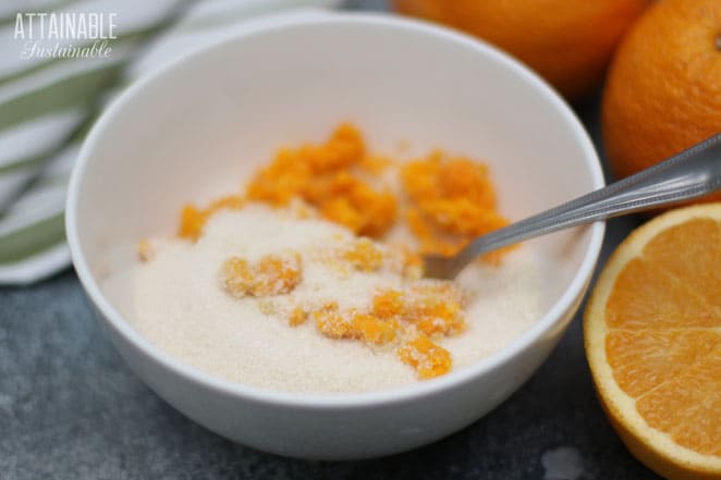 fork mixing orange zest into sugar