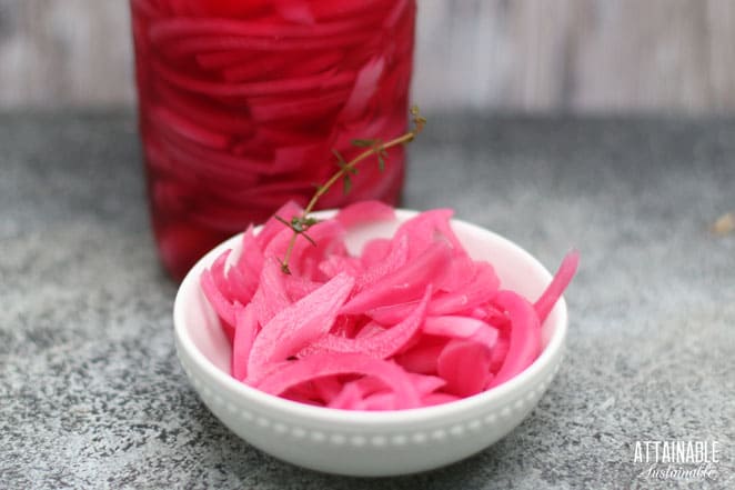 bright pink slices of onion in a white bowl