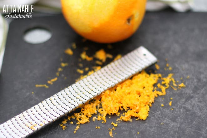 microplane on a cutting board with orange zest