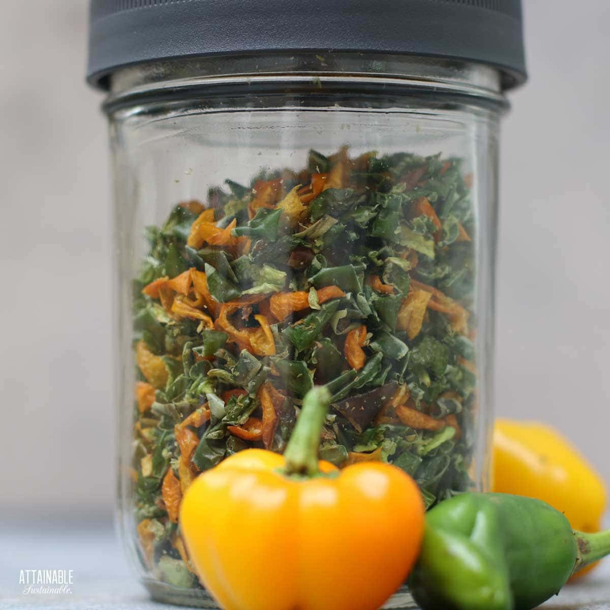 mixed yellow and green dehydrated peppers in a jar.