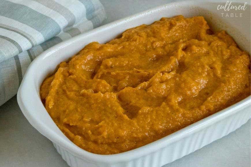 mashed sweet potatoes in a white casserole dish
