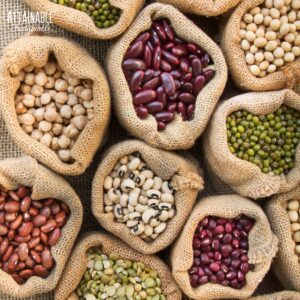 various dried beans in burlap bags, from above.
