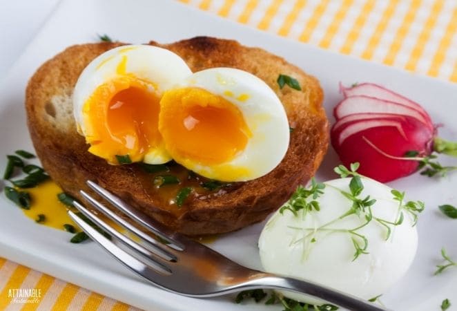 soft boiled egg on a plate with toast and radish garnish