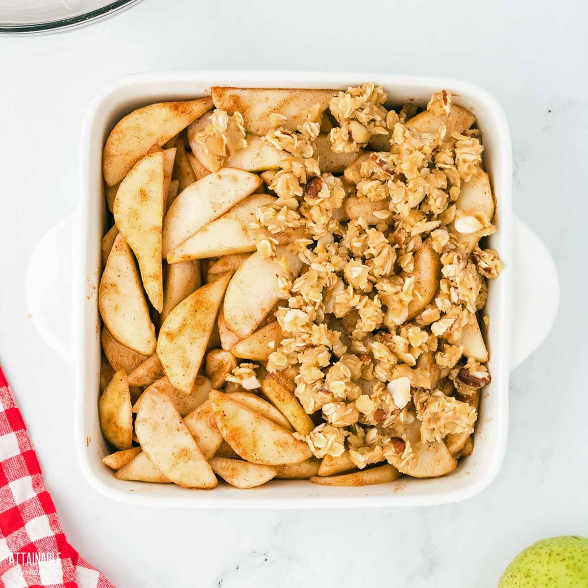 pears in a baking dish, half covered with topping.