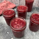 Tamarillo jam in jars, lids off.
