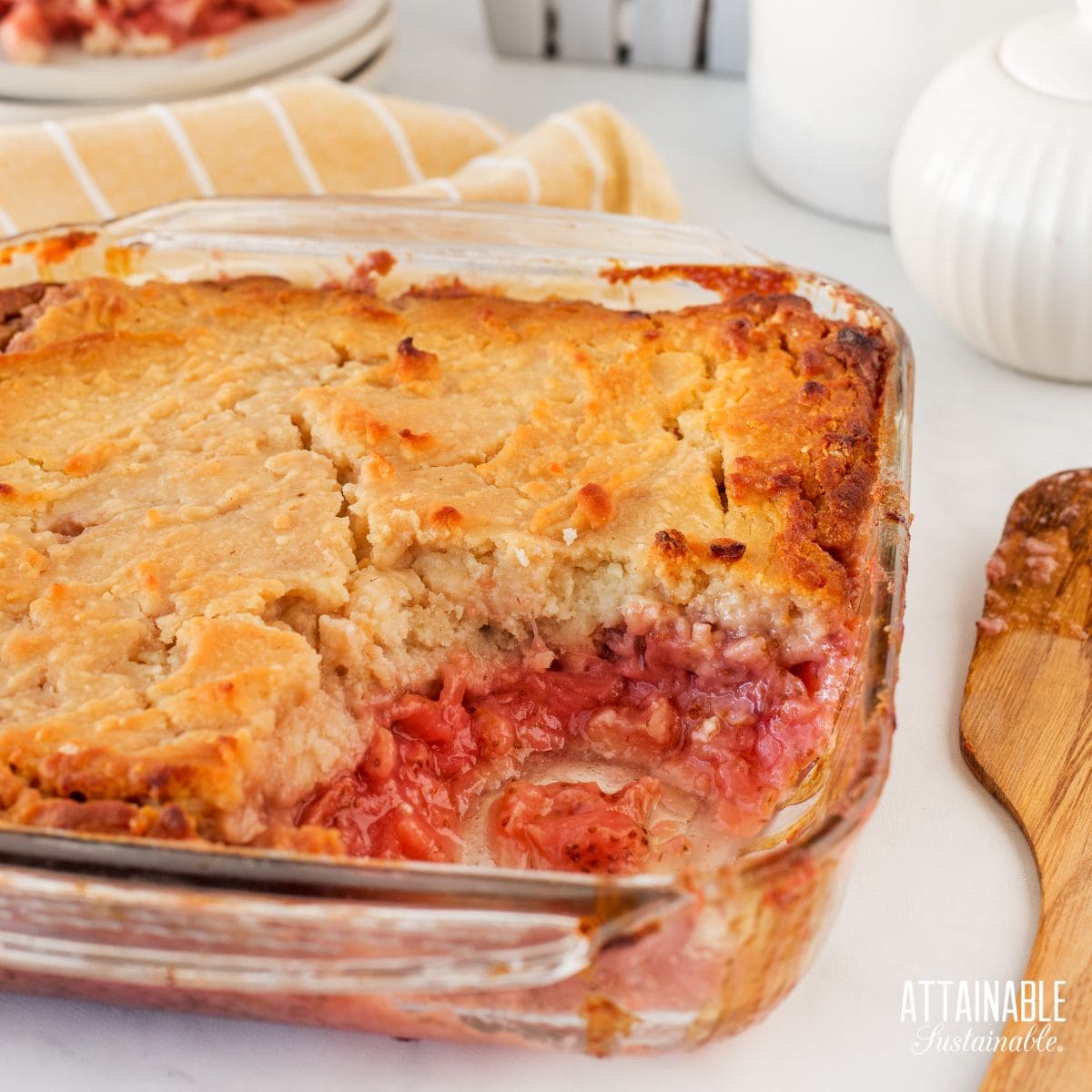 Strawberry cobbler in a pan, one piece removed.