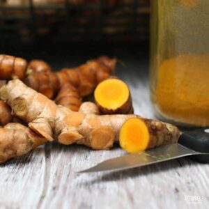 turmeric roots, some cut open showing bright orange color.