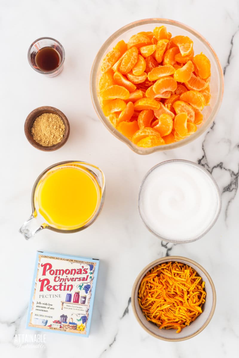 ingredients for tangerine marmalad on a marble background.