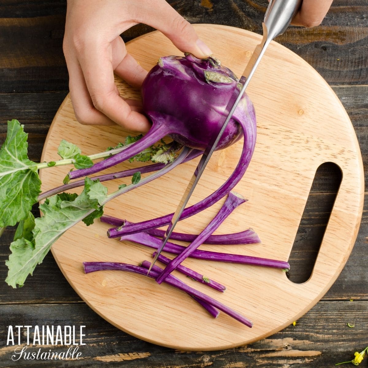 Purple kohlrabi being cut with a knife on a wooden cutting board. 