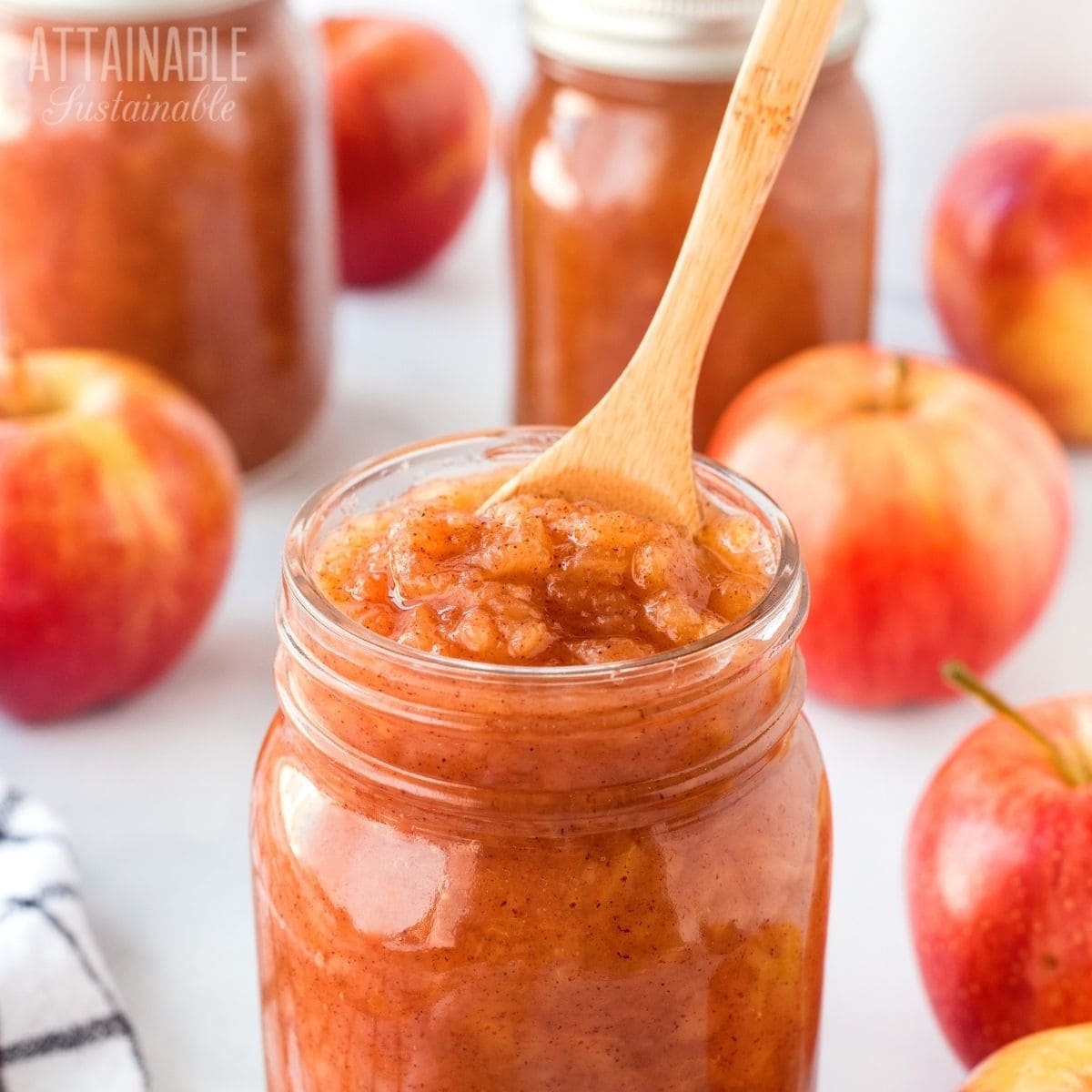 jar of canned applesauce with a spoon in it.