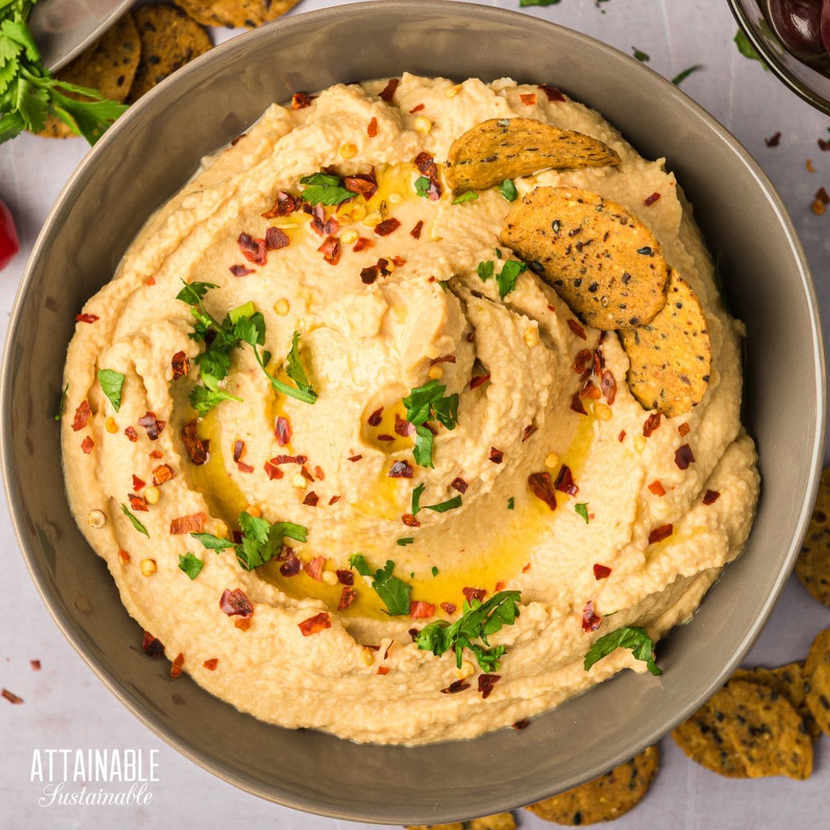 chipotle hummus in a brown bowl from above.