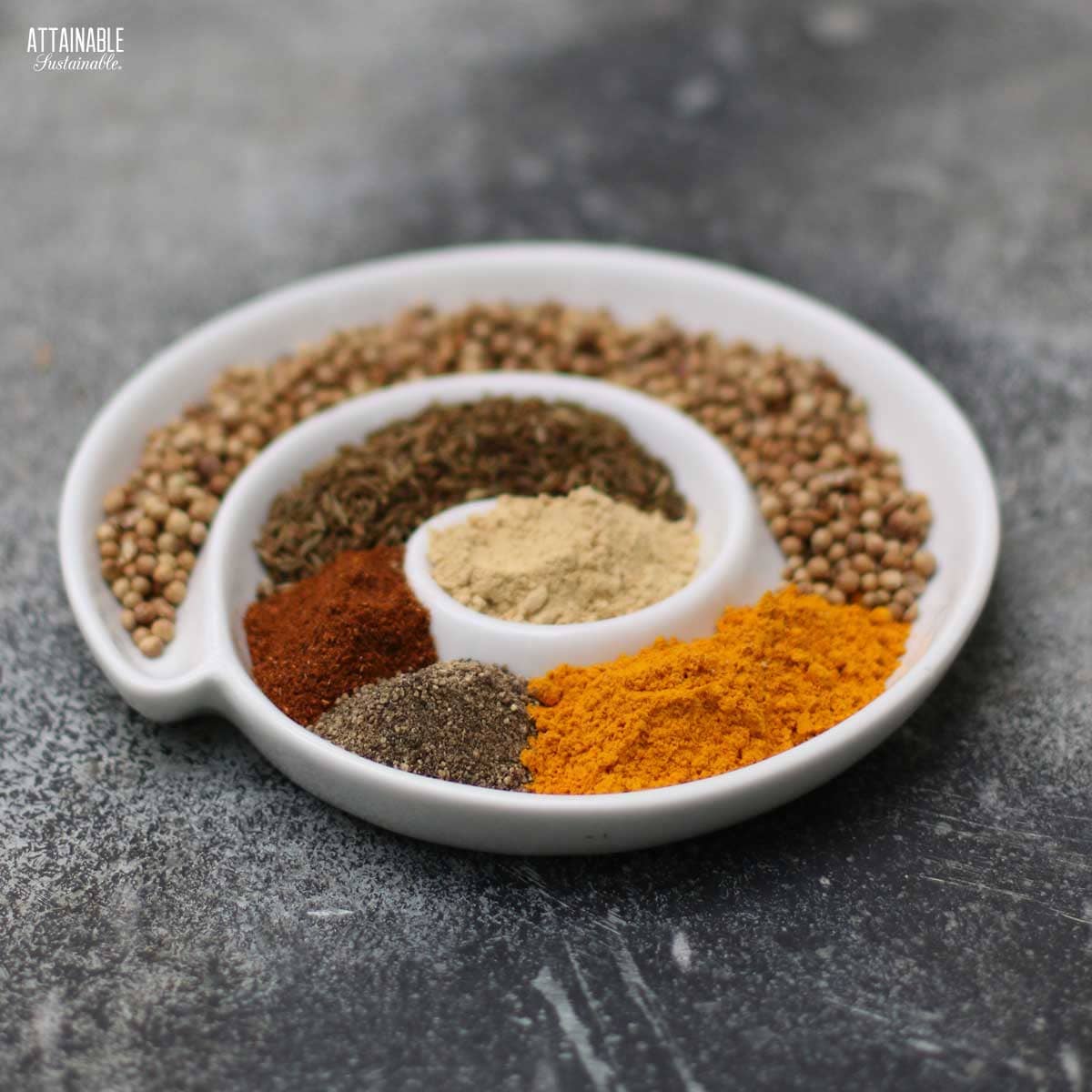 various spices in a spiral shaped dish.