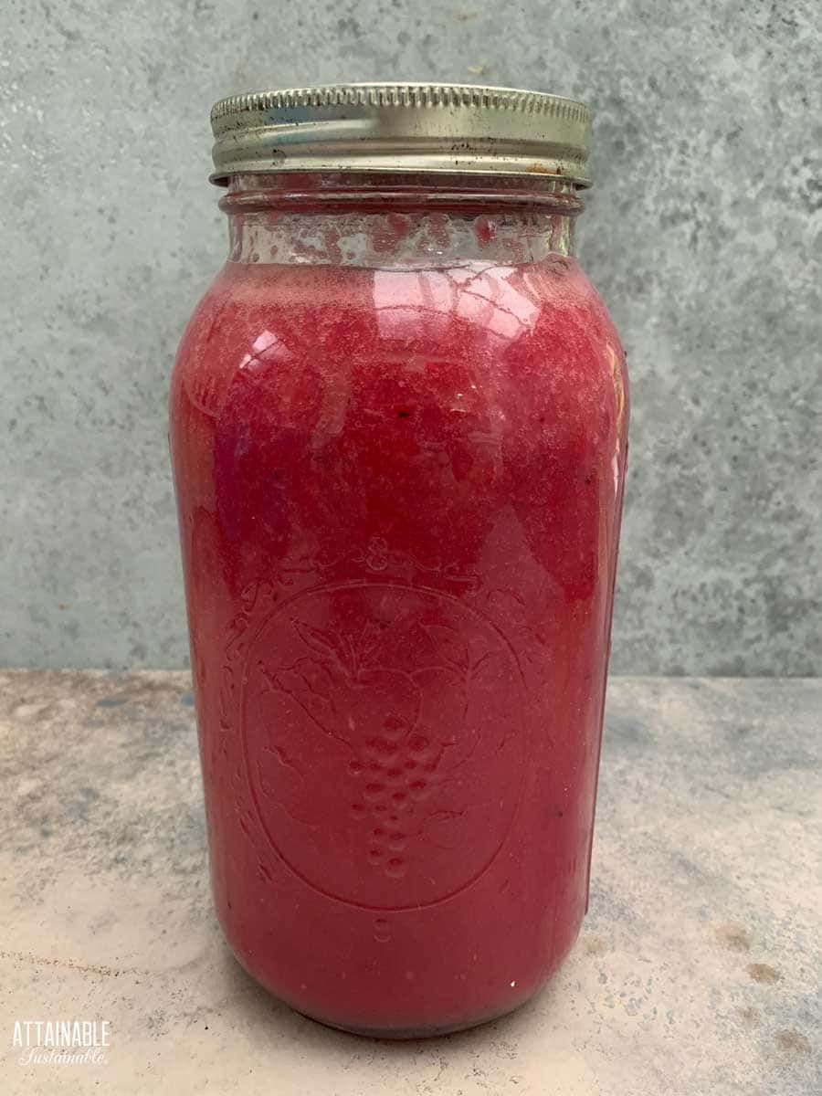 pink juice in a large jar.