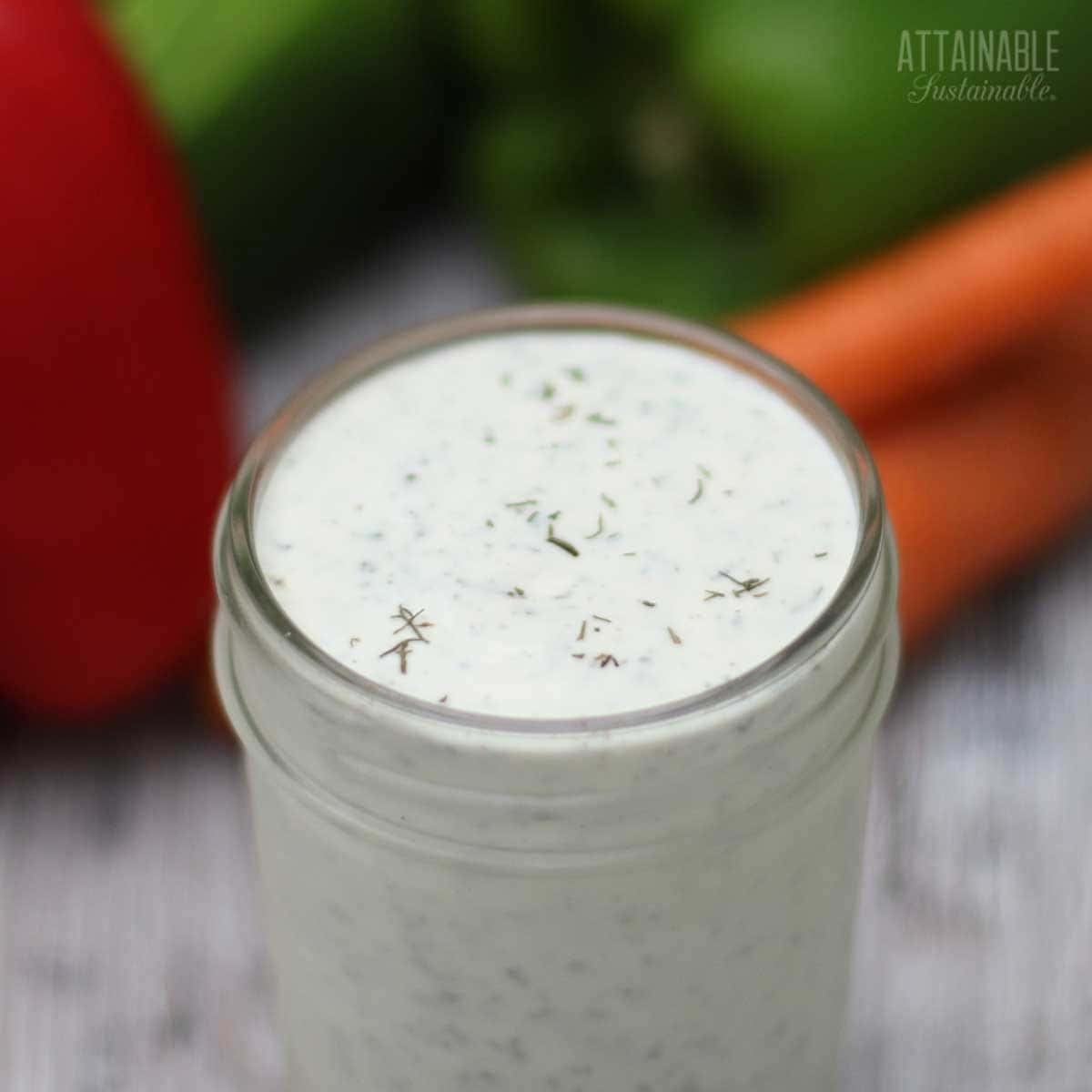 HOMEMADE ranch dressing in a jar with lid off. 