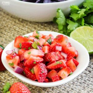chopped strawberry salsa in a white dish.