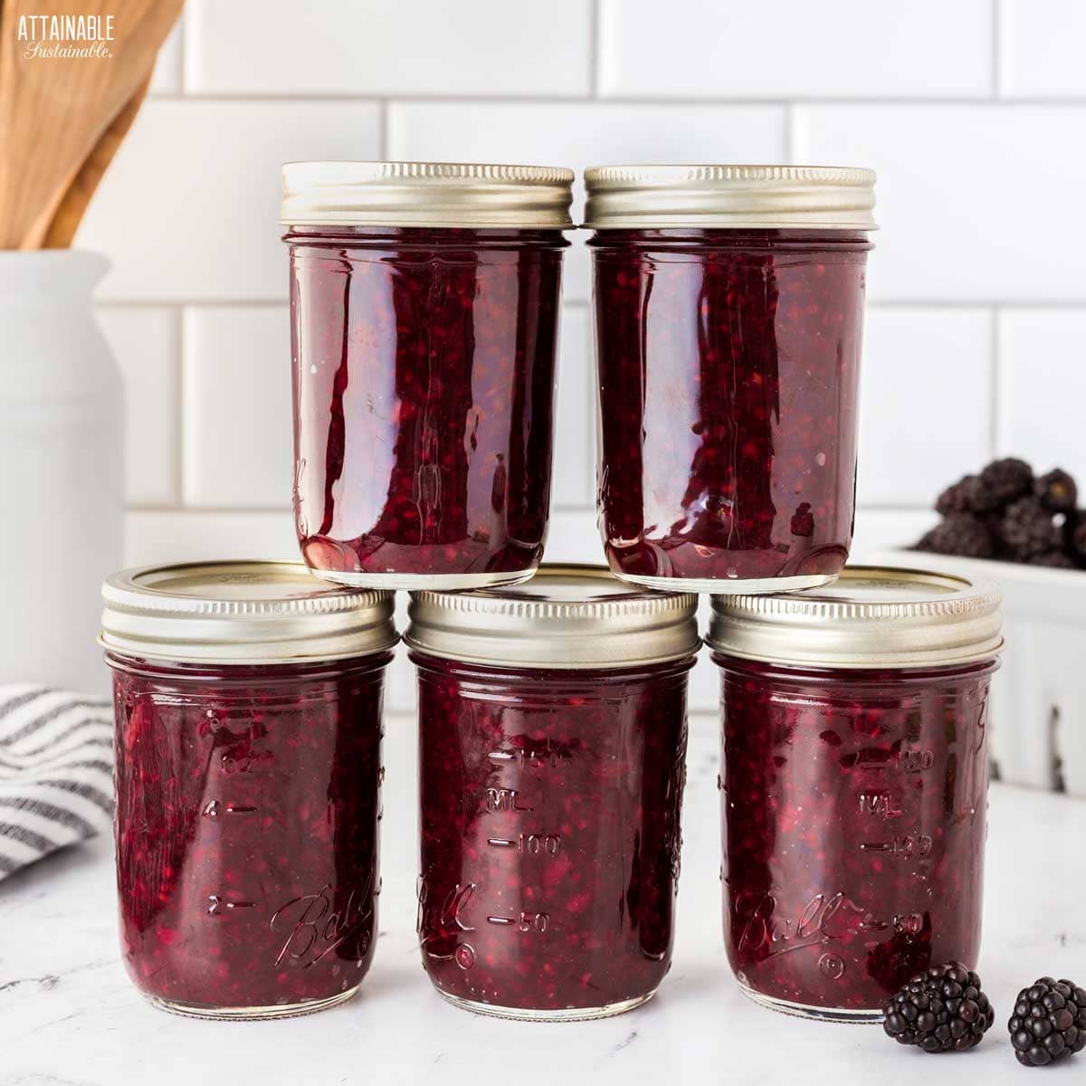 jars of blackberry jam, stacked.
