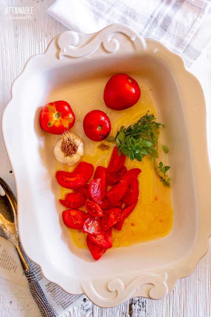 ingredients for tomato soup in a white casserole dish.