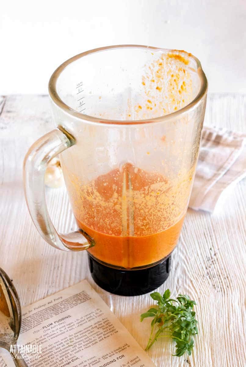 blender carafe with orange liquid in it.