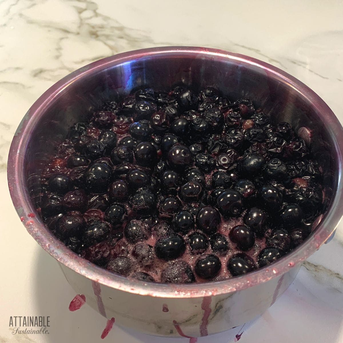 cooked blueberries in a saucepan.