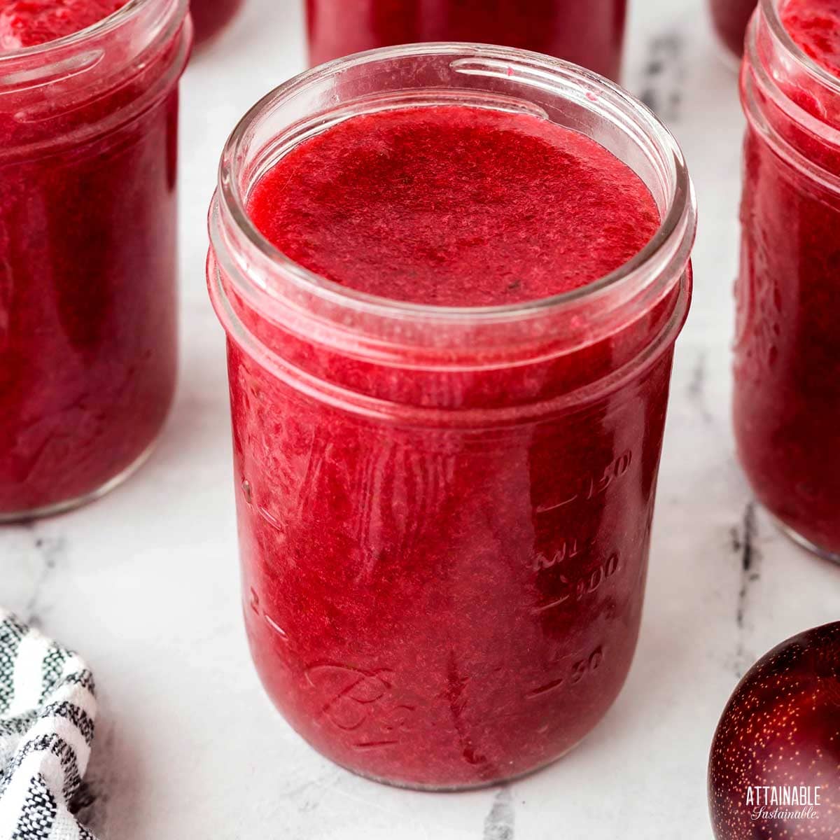 jars of purple fruit spread with lid off.