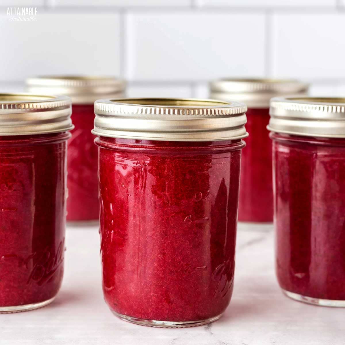 canning jars of plum jam.