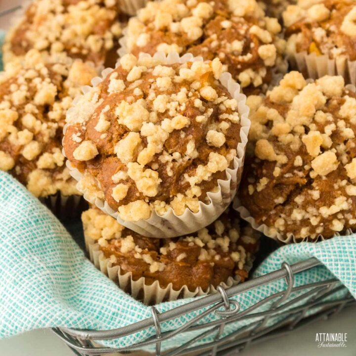 muffins in a basket with a teal towel.