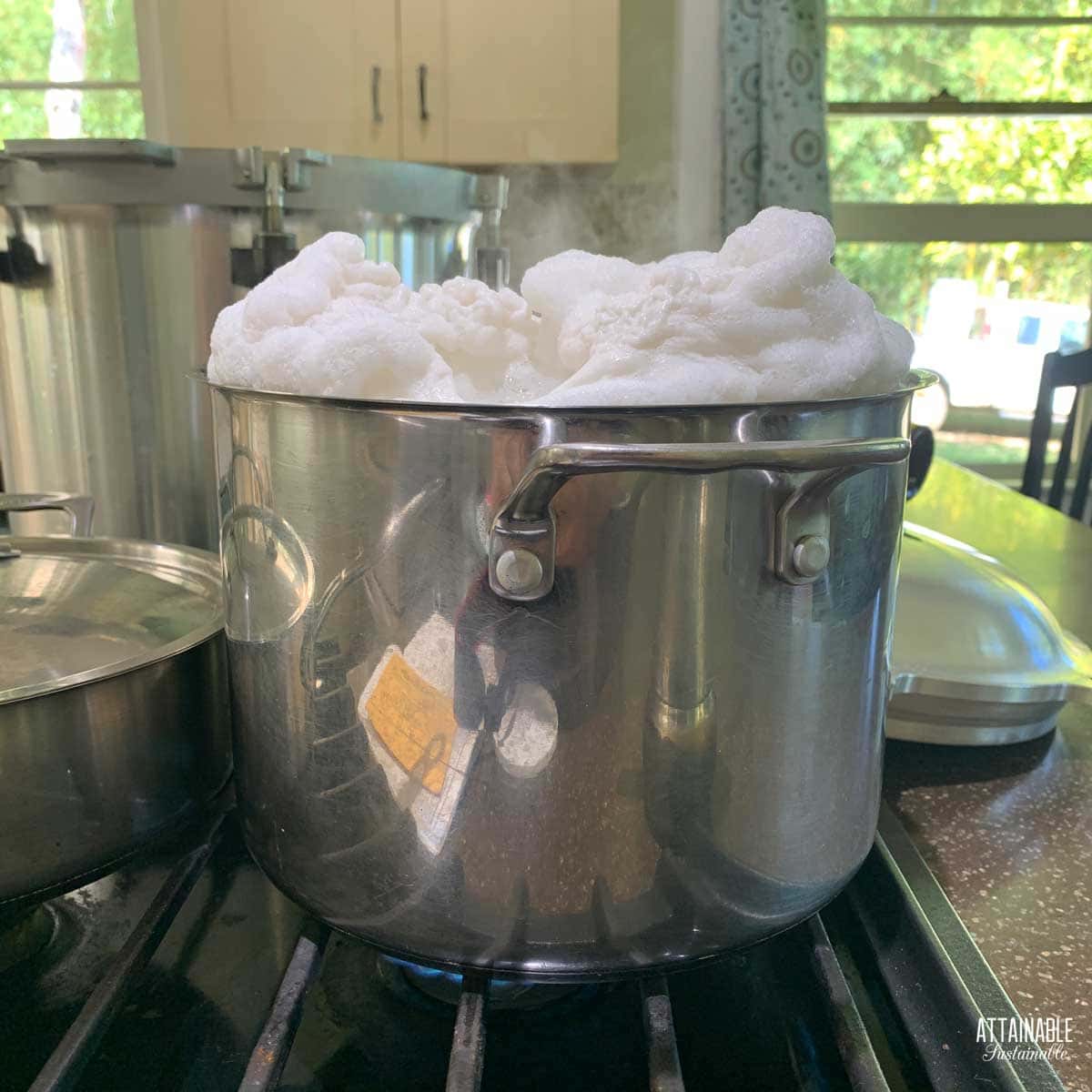 stock pot with white foam overflowing.