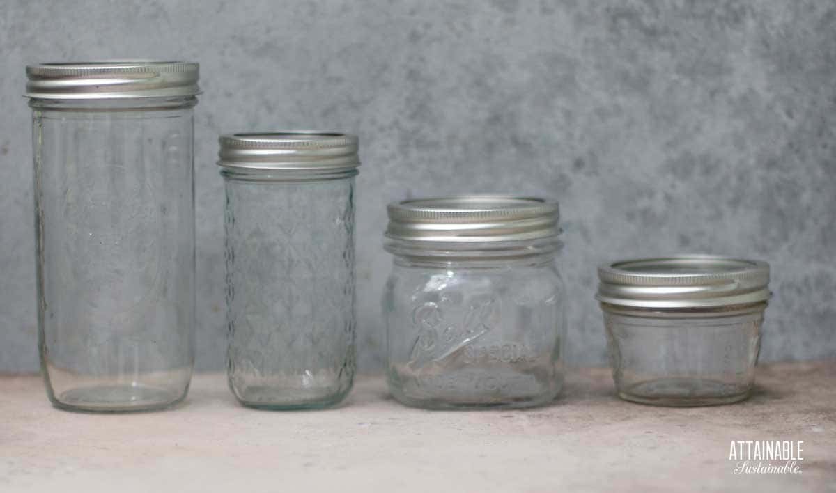 4 empty canning jars in different sizes.