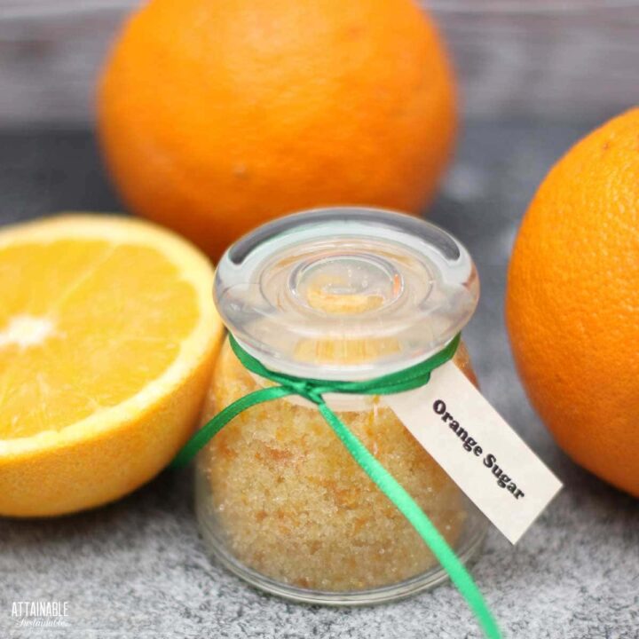 small glass jar with orange sugar.