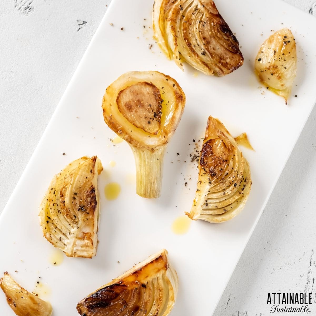 Cut and roasted fennel on a white plate.