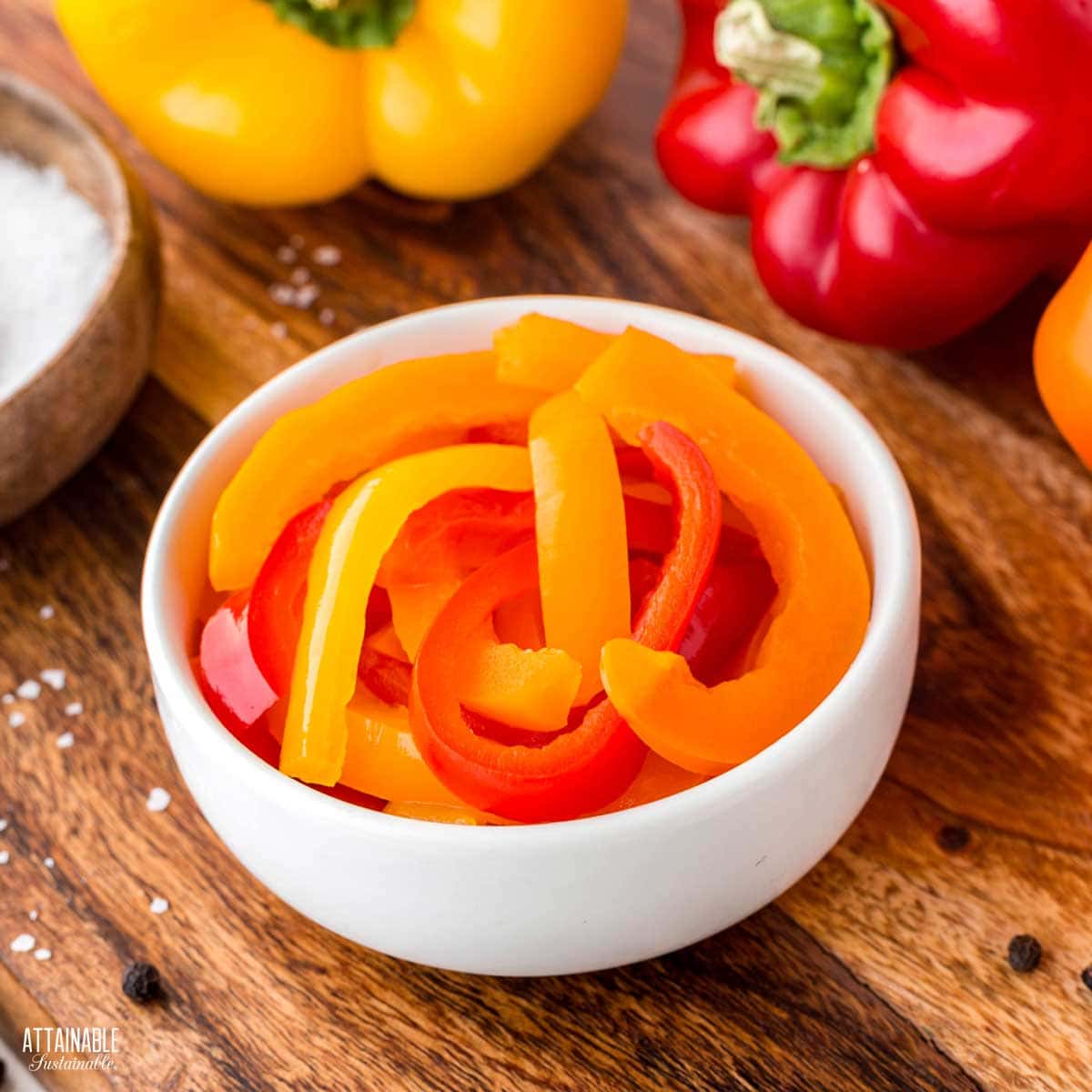 colorful sliced sweet peppers in a white bowl.