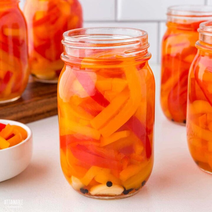 jar of red, yellow, and orange pickled peppers.