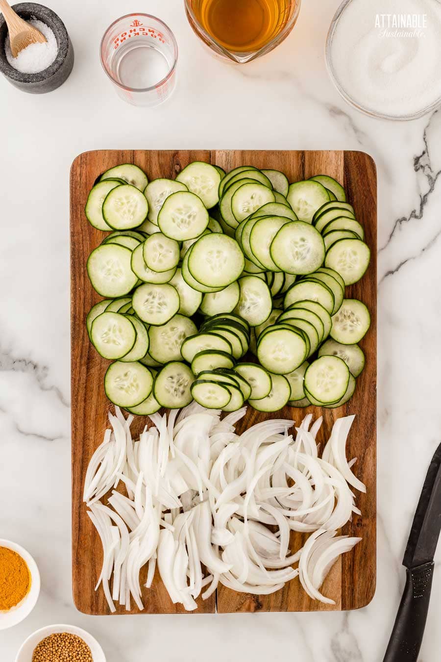 cucumber rounds and onion slices on a cutting board.
