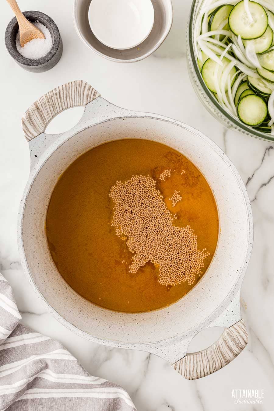 pickle brine in a white pot.