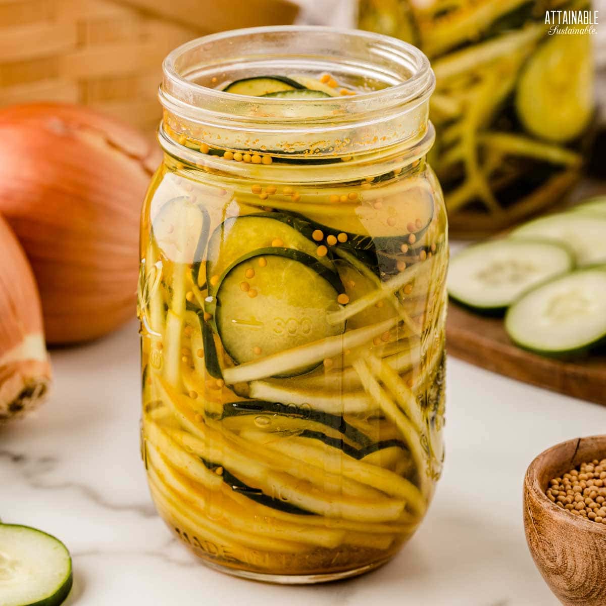 jar full of bread and butter pickles in brine.