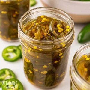 half pint jar full of candied jalapenos.