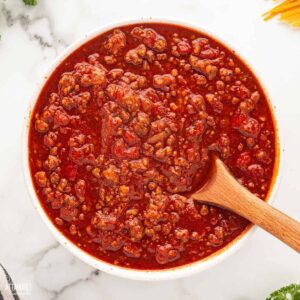 red sauce with meat in a white bowl from above.