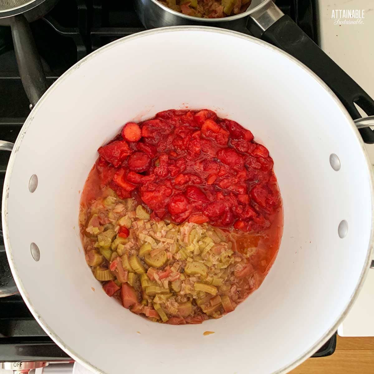 cooking strawberries and rhubarb in a pot.