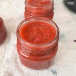 jars of strawberry rhubarb jam, before setting lids in place.
