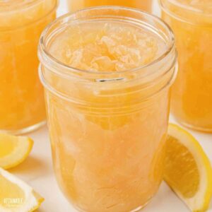 An open jar of homemade lemon marmalade.