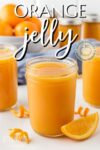 Canning jars filled with orange jelly before processing.