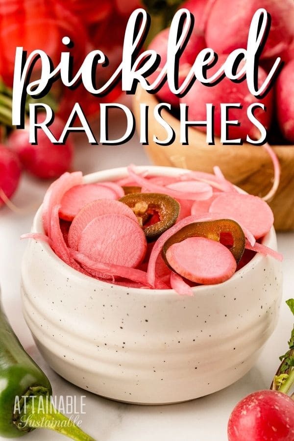 white crockery bowl full of pink pickled radishes.