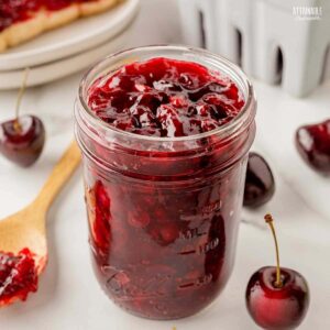 jar of cherry jam, lid off.