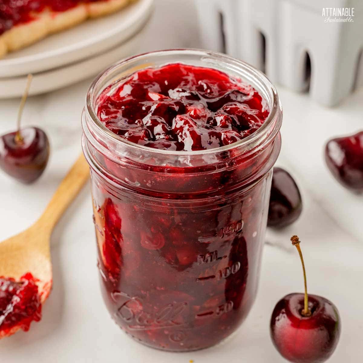 jar of cherry jam, lid off.