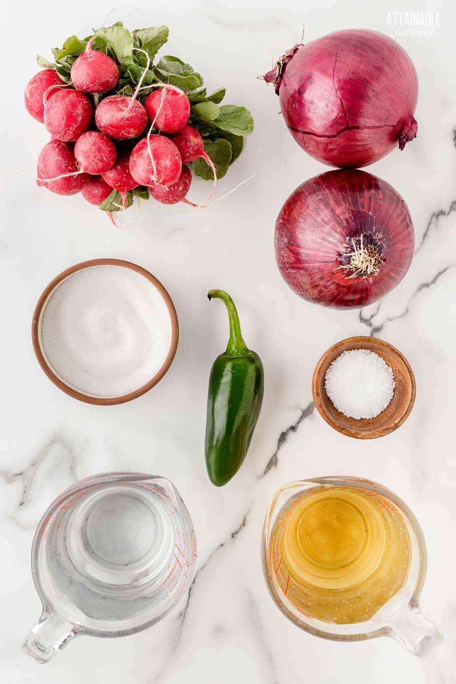 ingredients for pickled radishes on a marble background.