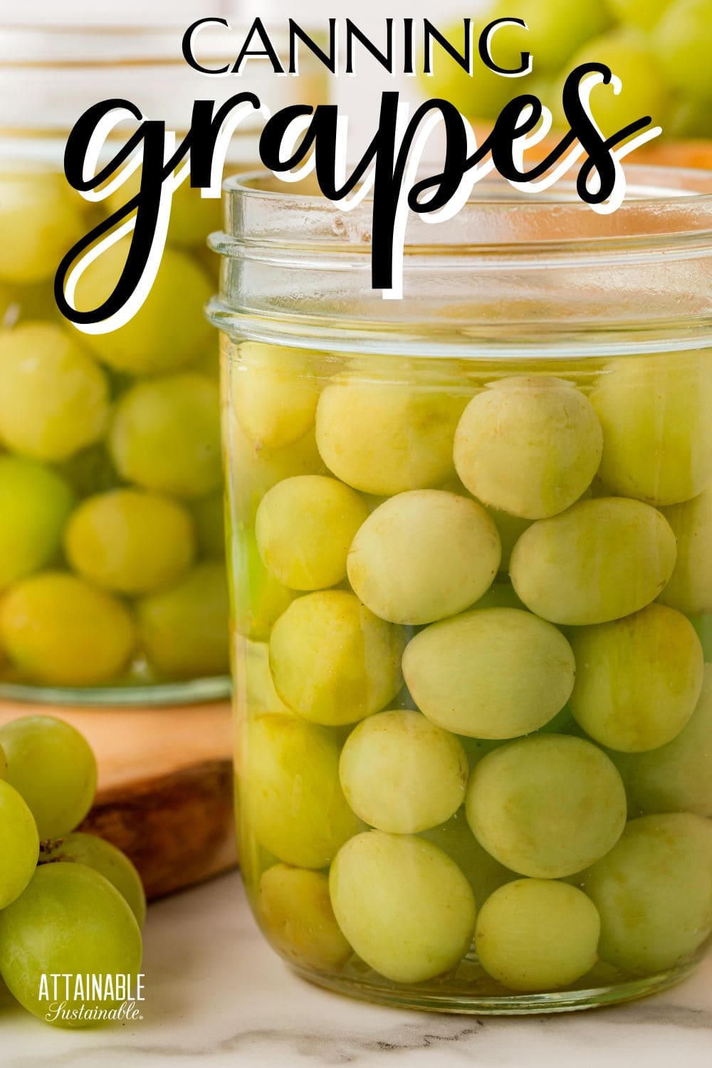 mason jars full of green grapes without lids.